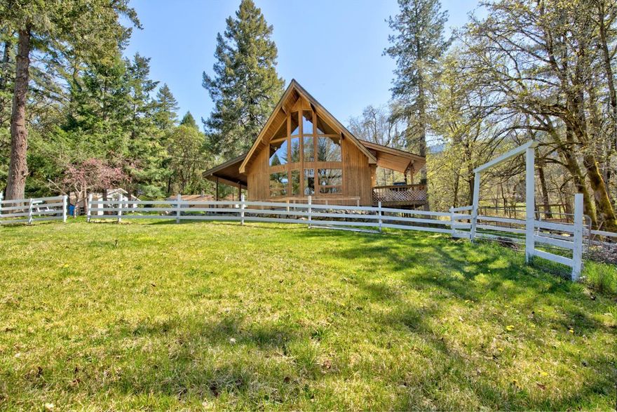 Appealing multi-use property on a beautiful 37.4 historic acres with two homes. Year-round Grays Creek runs through it with water rights. Water rights are also available from a pond. An expansive field for planting and/or livestock, and a lovely forest, all on a tucked away feel. The main home, 3 bedroom, 2 bath with two bedrooms down and the master upstairs, plus a single level 2 bedroom 2 bath guest house. The guest house has fresh paint & a new roof. 75 gpm well when drilled. Home Warranty included on both homes. Just around the bend from Murphy and a few minutes more to Grants Pass.
