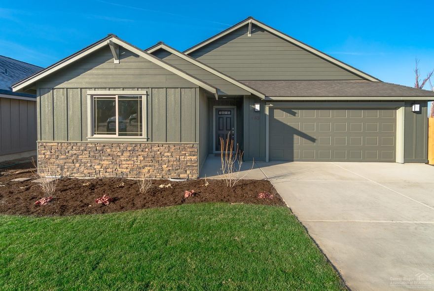 Looking for a perfect place to live, play & entertain? Vaulted great room floor plan with central working island & open dining. Corner gas burning fp w/stone surround. Kitchen features lg corner pantry, SS appliances, full height backsplashes & crown molding. Quartz slab counter tops throughout. Engineered wood look flooring in common spaces. High efficiency gas furnace & A/C installed! Dbl garage, front & rear landscaping w/sprinklers, covered patio & fully fenced. Model home @ 3020 NW Cedar Ave. Thu-Mon, 11-4pm