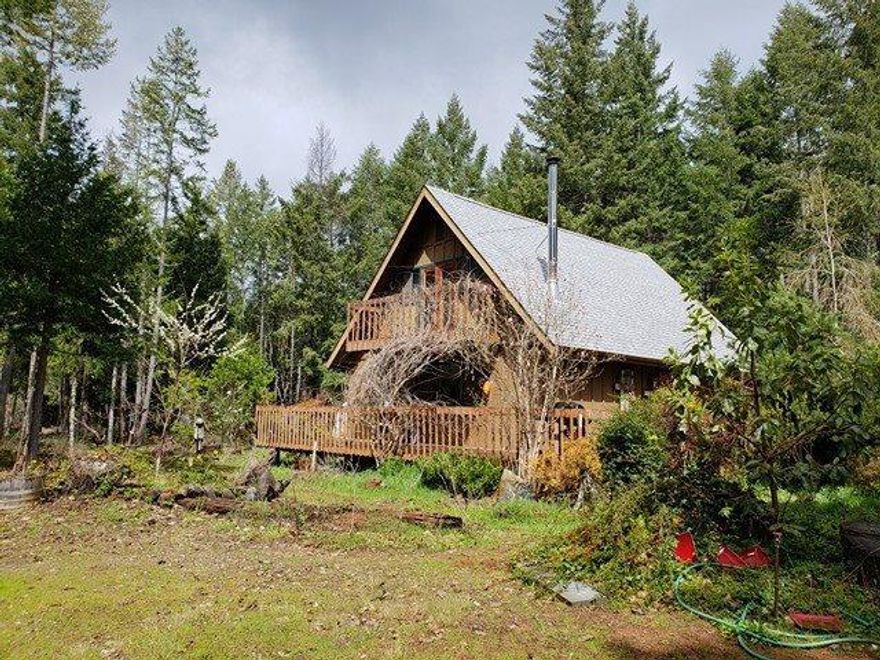 Three bedroom two bath home in Selma on 6.20 wooded acres.There is an attached two car garage. Bedroom upstairs has french doors that open to a balcony. Large deck, garden area, green house, garden shed,a decorational pond. Gazebo over looking the creek. New Roof in February 2018. Appr. 3 miles to Lake Selmac. Zoned FC.