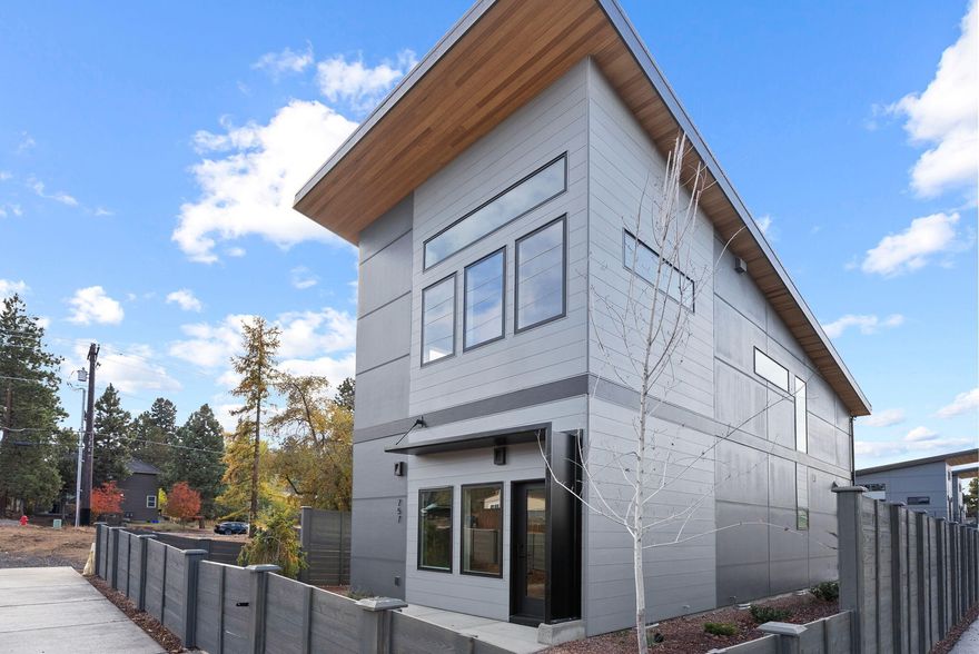 Just around the corner from Bend's iconic Old Mill District, this move-in ready, new Hiatus home, designed by 2024's High Performance Builder of the Year, offers exceptional design and an unbeatable location. Inside, vaulted ceilings and expansive windows highlight quartz countertops, stainless steel appliances, custom cabinetry, and engineered hardwood floors. Bedrooms are true dual primaries, each with its own ensuite bath. Net-zero ready, this home scores 10/10 HES and includes advanced insulation, fiberglass windows, a durable metal roof, efficient mini-split heating and cooling and an EV-ready garage.