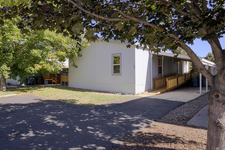 Welcome to this well-maintained manufactured home in a friendly park community. Inside you'll find fresh interior paint, updated flooring, and a remodeled kitchen with a spacious walk-in pantry. The thoughtful floor plan offers a private primary suite separated from the guest rooms. Outside, enjoy the convenience of a covered carport, storage shed, and a brand-new wheelchair ramp for easy access. The fenced backyard provides a secure space for pets, gardening, or relaxing outdoors. Monthly park fees include water and sewer, making this home both comfortable and affordable.