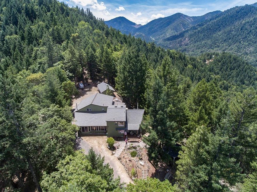 Don't let the long steep driveway and the plain exterior deter you; wait until you walk in the front door and see the interior! Wow! Beautiful tongue and groove knotty pine walls and ceiling that soar two stories with huge windows that bring in the breath taking views from the totally private 25 acre Oregon get-away. The home has 3 bedrooms and 2 baths along with the living/dining and kitchen as well as the Man Cave complete with wet bar. You'll also enjoy the large pantry. The woodworker will love the 28X30 shop connected to the attached one car garage as well as a detached 3 car garage and an additional metal shop sized outbuilding as well.