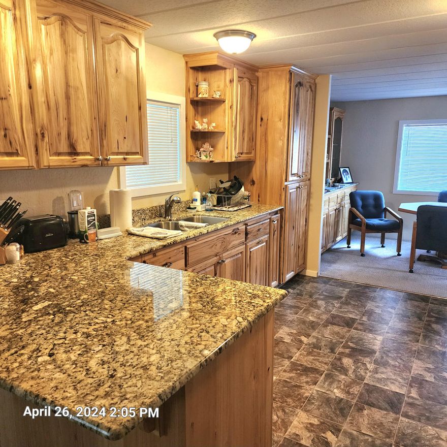 Amazing remodel on this double wide home in the Rogue Lea Estates.  Knotty Hickory cabinets, granite counter tops, remodeled baths, professionally painted inside and out,  new roof in 2018, upgraded flooring. A very quiet and peaceful environment with the ponds and Clubhouse very close by.  Motivated Seller. Willing to consider all offers. Seller will pay for a one-year home warranty of buyers choice up to $500.