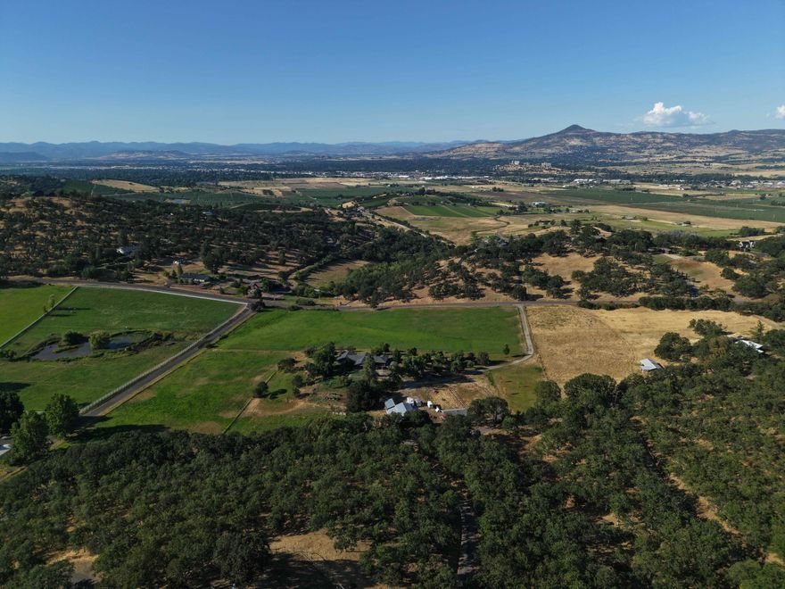 This 5.92-acre property has it all. Sweeping vistas and total privacy on a coveted central location. Build at the top of the parcel to take in panoramic views of the Rogue Valley, from Table Rock and Roxy Ann to Grizzly Peak. Or tuck your home lower on the land for unmatched seclusion and quiet. At the end of a shared drive and surrounded by estate properties, this peaceful setting feels worlds away, yet is just minutes from the restaurants, shopping and medical care of Ashland, Jacksonville and Medford. Ready for your vision, with septic and homesite approvals and a high-producing well (40 GPM when drilled). Owner may carry at 5% interest with 50% down, 30-year amortization, and balloon payment in 5 years.