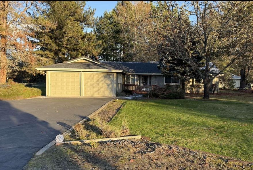 Charming Country Home in District 7 with Deeded Rouge River access. Nestled in a quiet, desirable neighborhood, this well-maintained home sits on a level, fully landscaped acre with irrigation. The beautifully manicured grounds features variety of mature fruit trees, creating a peaceful, private retreat. This 1888 sq ft 3 bad 2 bath home boasts vaulted ceilings throughout the spacious living room, kitchen, and large master suite, enhancing the open, airy feel. The kitchen has recently been remodeled with modern finishes, and new flooring flows seamlessly throughout the entire home.