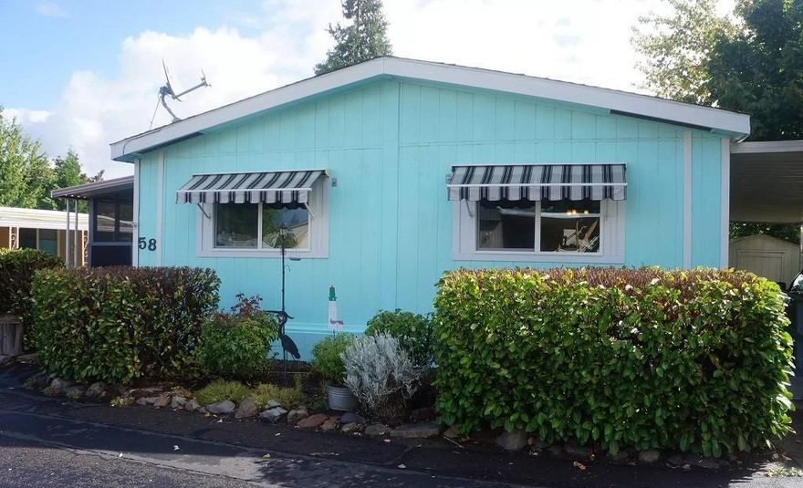 Lovely double-wide in the desirable 55+ CandleWood Park in Talent -- only three miles from Ashland. This 3-bedroom 2 bath home has over 1500 square feet and was built in 1984. This home features large rooms with vaulted ceilings, new laminate floors, vinyl windows and a sunny, open floor plan. Remote controlled window awnings on the front of the home keep it cool on sunny days. A screened-in front porch is perfect for your little pet with a pet door already installed in the door for easy access! Wheelchair friendly with a ramp from the long carport and a step-in shower. Appliances are included, including a brand new heat pump. New roof! The park rent is $515/month including garbage. It's a great setting and an easy stroll to downtown Talent. Try this for sighs.