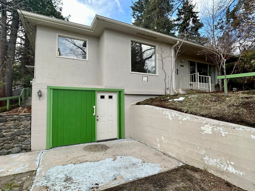 1953 mid-century modern home above the boulevard near Southern Oregon University. The main level features a spacious living room, hardwood oak floors, large picture windows, wood-burning brick fireplace with beautiful wood mantle, formal dining room with antique art-deco chandelier, kitchen with built-in hutch and attached bonus room, sunroom with sliding door to the back yard, two bedrooms and one full bathroom with charming original tile counter and tiled shower/tub. The finished daylight basement features a spacious bedroom suite; full bathroom with shower; laundry facilities; and ''half-garage'' perfect for storage or workshop. Located on nearly a quarter acre lot, the yard has a lot to offer including slate tile walkways and platforms for dining and/or lounging, painted wood railings, retaining walls, terraced landscaping, water feature and mature trees. Deep gravel driveway provides off-street parking.
