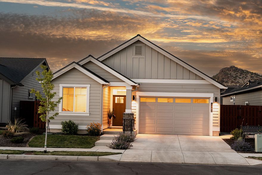 Discover this nearly new single-level home with inviting southern exposure. An open floor plan seamlessly connects the stylish kitchen—complete with eating island and dining area—to a vaulted great room that features a gas fireplace and tall sliding doors, flooding the space with natural light. Step outside to enjoy a spacious covered patio with peek-a-boo views of Barnes Butte, perfect for relaxation or entertaining. The front bedroom has ensuite access to a full bath, while upgrades include a primary suite door leading to the patio, a garbage bin in the kitchen island, under-cabinet lighting, solid wood shelving in the pantry and closets. Highlights include full-height tile backsplash, tiled shower in the primary suite, & AC for year-round comfort. This vibrant community boasts excellent amenities such as parks, a swimming pool, a picnic pavilion, a children's playground, and a half sports court, along with a scenic pathway leading to Prineville's Barnes Butte public walking trails.