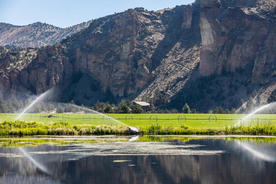 The original Headquarters at Ranch at the Canyons is magical. The sweeping spires of Smith Rock state park & the meandering Crooked River surround you. The views are jaw dropping. Witness the flights of eagles while enjoying the warmth of the sun as you gaze towards Monkey Face or turn your head to take in the full Cascade mountain views. This unique proximity to the river has been grandfathered in creating a truly special, private & peaceful space. As the gates open to the ranch the only roof top you see is the Headquarters. As you enter the Ranch and drive through the vineyard toward home the smells of juniper & sage abound.  Relax in the peaceful quiet or enjoy the outdoors. With miles of private river access for fly fishing, the community club house, stables, picnic areas and private hiking trails there is a lot to choose from. This special home is less than 20 minutes from the Redmond airport. Close to Mt. Bachelor for skiing and multiple renowned golf courses.
