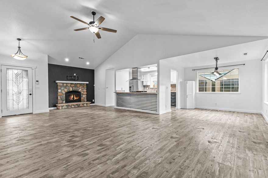 Move-in ready, low maintenance, and perfect for entertaining! This light and bright home features an open floor plan with vaulted ceilings, luxury vinyl plank flooring, and a cozy gas fireplace. Granite counters, updated fixtures, lighting, and a true pantry, with laundry conveniently located off the garage. The backyard is made for fun with new turf, covered patio, gazebo, and flat-screen TV with custom hard cover.  Enjoy raised garden beds, fresh veggies, new fencing, and easy-care landscaping front and back. Relax in the private sauna (220V installed) and appreciate added touches like a central vac system and stylish new vanities. TRUE GATED RV parking, 2 storage sheds, plus close proximity to walking paths, parks, schools, and shopping make this home a standout!