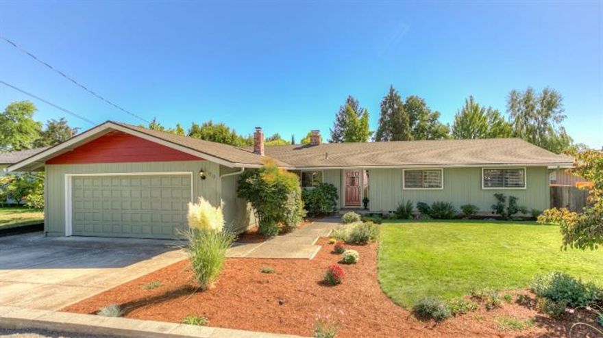 Charming single level home in older East Medford neighborhood close to schools and shopping. Warm and inviting with great curb appeal and wonderful updates including new laminate floors, new interior and exterior paint, all thermo windows, new window coverings, new Quartz countertops in the baths, new fixtures, solid wood interior doors and new hot water heater. Formal living with brick fireplace, large formal dining room with oversized slider to covered deck ideal for your outdoor entertaining and roomy master suite complete with full bath. The cozy kitchen offers newly painted cabinets, tiled counters, new dishwasher, new stainless sink and breakfast bar. New composition roof in 2004, new heat pump in 2013, fully fenced back yard, indoor utility room, 2-car attached garage and plenty of paved off street parking with beautiful mature landscaping. You will not be disappointed in this wonderful old east Medford home!