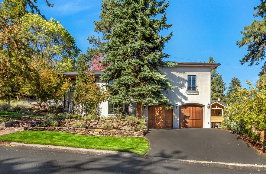 Private oasis in the heart of Bend's vibrant westside. Situated on a double corner lot, the
property feels like a private estate, while also being within walking distance of the Deschutes
River, downtown, and many of Bend's most popular amenities. The home has been seamlessly
updated to combine modern luxuries with classic, timeless finishes. The main level features an
open floor plan with a spacious master suite, built-in office, and 2 additional guest suites- each
with an en suite bath. Bathed in natural light and overlooking the backyard, the chef's kitchen is
a show stopper- complete with stone countertops, Viking appliances and butcher block island.
The expansive outdoor space is perfect for entertaining, or as a tranquil retreat and the
additional tax lot included and extra detached garage offer endless possibilities. Downstairs you
will find a family/media room with surround sound, 300+ bottle wine cellar, plus additional flex
space. Oversized 2 car garage with workshop.