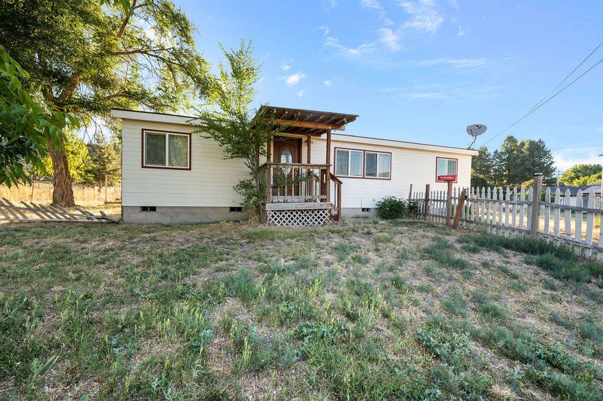 This home is Perfect for someone who is seeking a serene country feel! This charming Manufactured  home sits on .74 acres of ample outdoor space.
The house itself is a cute 3 bedroom, 2 bath, 1125 sq ft. home. The spacious kitchen has had some updates. Newer counters in both bathrooms. 
There is the generously sized 2 car garage that comes with a connected workshop area. This space can cater to a multitude of uses, from a haven for your DIY projects to an additional storage area. 
Whether you're a chicken lover, a goat enthusiast or simply someone who appreciates a peaceful setting, this property offers plenty room for everyone.  With its beautiful features and peaceful surroundings, it's the perfect place to call home.