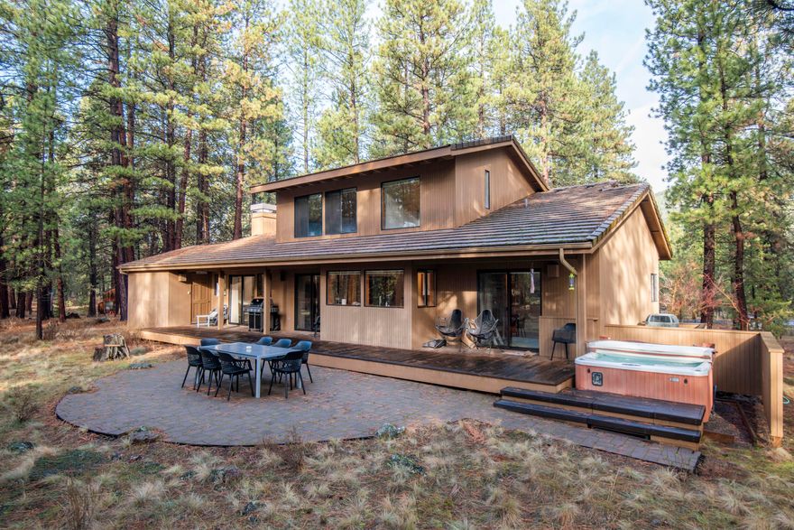 Sitting on a slight bluff, EM25 enjoys privacy, with views of the serene forest setting and access to hiking trails from the back yard. Bonus view of Black Butte from the front porch. The main floor flows smoothly from the living area, with wood burning fireplace and slider door to the patio, to the dining area with a slider door to the patio. The patio has a hot tub. Kitchen has plenty of room for the cooks, and bystanders at the island breakfast bar. There are 2 bedrooms - one has a slider door to the patio. There is a bathroom with a stall shower. The utility room has a toilet and sink. 2nd floor is all about the primary bedroom. It is your private sanctuary with a separate tub and shower. Plus, a very large walk-in closet that opens to extra storage area. The 2-car garage is currently set up for ping pong, bikes....fun. Enjoy 2 championship golf courses, tennis/ pickleball courts, 6 pools (1 indoor), hot tubs, workout rooms, spa, paddle boarding, kayaking, plus 3 Restaurants.