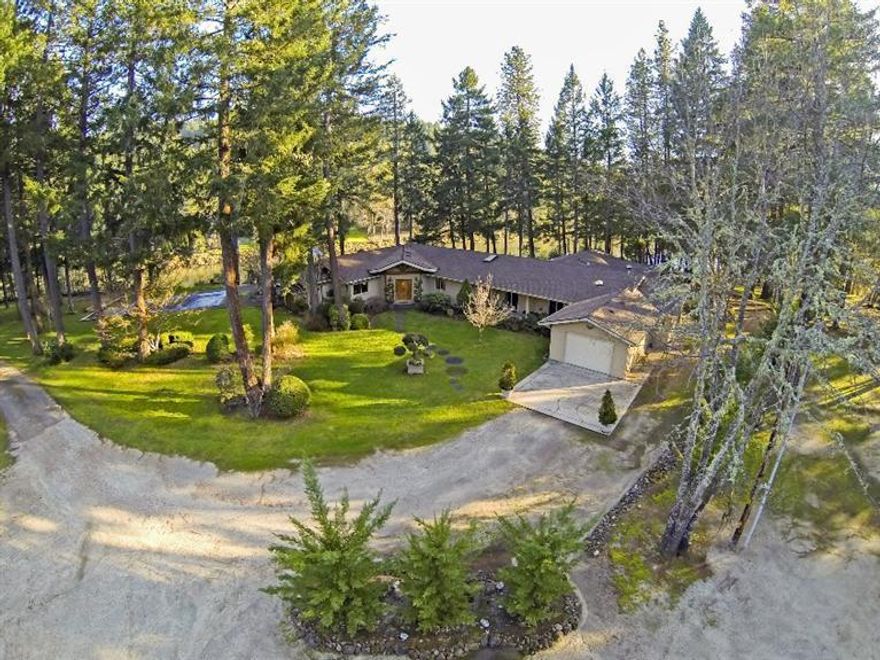 A Private Oasis awaits you on this beautiful 10.33 Rogue River front acres; two tax lots. Amazing Rogue River and mountain views in this tranquil and serene setting, inground pool, large deck to relax on. A gorgeous 4 bedroom, 4.5 bath home with library/office and 3940 sf. of estate property. Gourmet kitchen with gas cook top, granite counters, island, large pantry, skylights and SS appliances. Stunning Great Room with large picture windows to frame the views; vaulted ceiling, slider to the deck. Lovely master suite will be your own spa get away with solid oak floors, vaulted ceiling, walk in closet, dual sinks,jetted tub and separate shower and beautiful wooded views. Private guest quarters is light and bright, bath with jetted tub, heated tile floor, walk-in closet. Enjoy all that nature has to offer; from the Rogue River, year round creek, paths meandering down to the river's edge. Shop is 30x37, machine shed 30x72, hay cover, established 100'x18'garden area. Two family set-up.