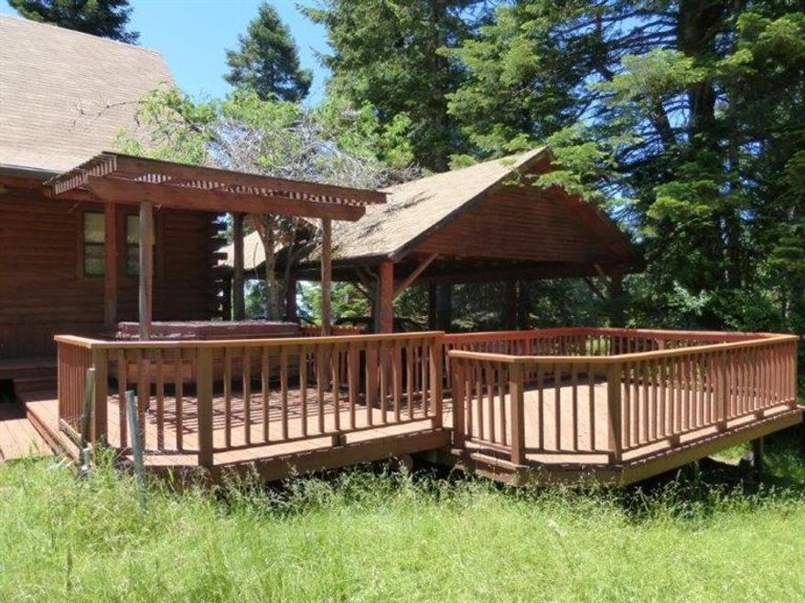 Enjoy the mountain air and fantastic views from this log home outside of Ashland on over 16 acres of pasture and forest. Unique log home with vaulted ceilings and open floor plan. Newly rebuilt decks surround the home and take in the views of the Cascades and Siskiyous. Fenced pasture and barn for livestock. Hot tub and wild pond complete the picture.