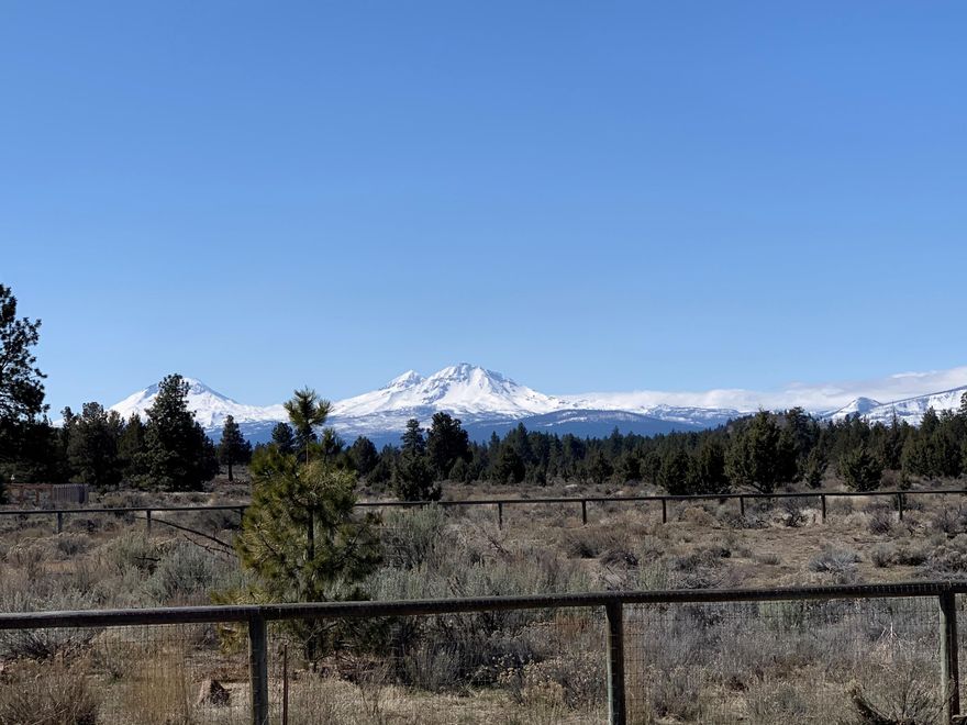 VIEWS of the MOUNTAINS from this 2-year young, custom home on 2.5 acres. Built by one of Sisters premier contractors and situated to take maximum advantage of the mountain views. A welcoming vaulted living room with a propane fireplace, a wall of windows, smart built-ins and exposed beams invite you to sit for hours. The dining area has access to the covered patio with Sundowner shades to extend indoor-outdoor living. The kitchen is a cooks dream with double wall ovens, propane Bosch cook top, Bosch dishwasher, pantry, quartz  countertops & island topped with black walnut. Primary bedroom on the main level with hot tub access, tiled walk-in shower, dual sinks and two closets. Powder room and separate laundry room with a handy bench. Upstairs 2 bedrooms, each with walk-in closet. Three heat zones in 2,283 square feet. Oversized garage, fenced backyard with low maintenance landscaping front and back and storage sheds round out this property.