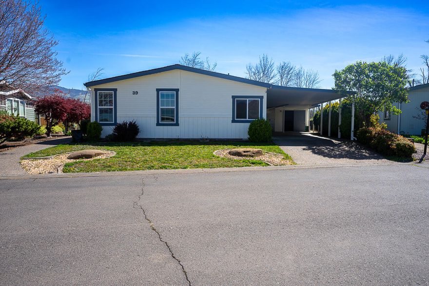 Nestled in a prime location within Mountain View Estates 55+ Manufactured home park, this home is a must see. Built in 1989, this home survived the Almeda fire with minimal fire damage to the property. The 1809 sq. ft. of living space includes 2 bedrooms, 2 bathrooms, an office/den, a living room, a family room, a dining room, and a lot of storage. Windows line the East and South sides of the home giving an abundance of natural light as well as views of Bear Creek and all of the wildlife present there. The kitchen includes a low bar with 3 chairs for casual dining and a brand new refrigerator purchased in December of 2022. The large driveway can easily fit 4+ cars and includes a spacious shed/workshop/office for all of your tinkering or storage needs. The home has been recently painted inside and out. Park allows a single pet up to 25lbs. The listing agent is related to the seller.