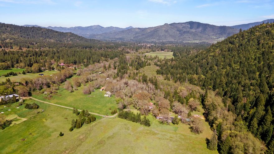 Welcome to this private, gated oasis situated on 41.76 acres (three combined parcels) in beautiful Williams, OR! Come enjoy wildlife right out your front door! 3 bed/2 bath w/ new roof and fresh interior and exterior paint. Multiple heat sources - wood burning stove, forced air/heat pump, & oil heating stove. Excellent well water pressure! Breathtaking views of the valley, mountains, and Williams Creek which runs through the property year-round, plus a spring-fed pond. Water rights with irrigation infrastructure in place provides incredible agricultural opportunities! Mature timber located on the backside of the property provides income potential with standing timber estimated at $175k. Fenced-in garden area with 8' fence. Property is also fenced and includes various outbuildings: 40 x 70 barn w/ spacious storage loft, chicken coop, wood shed w/ storage, pump shed & an add'l storage shed. RV parking and electrical hookup by creek. High speed fiber optics being installed down driveway.