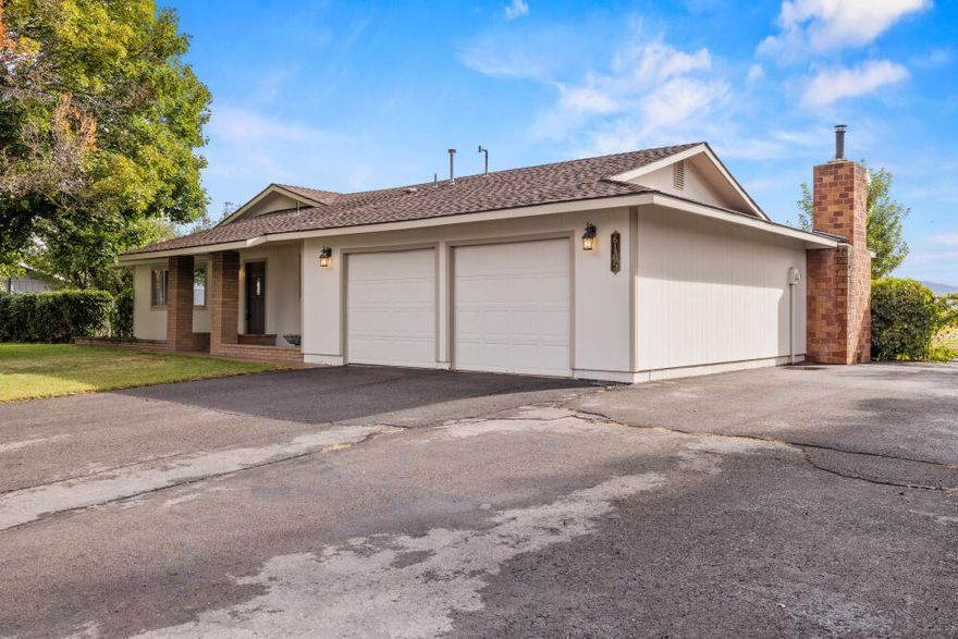 4 bedroom, 2 bathroom home situated on just under one acre, offering both comfort and functionality.  The property includes a 2-car garage plus a 36'x48' detached 3-bay shop, built in 2001 - perfect for RVs, boats, and all your toys, offering incredible versatility and storage.  The fully fenced yard features mature fruit trees, a large garden area with a garden house, and irrigation available through KID.  Enjoy outdoor living on the back deck, ideal for entertaining and taking in the peaceful and beautiful views.  Inside you'll find a a certified wood stove for cozy winters.  The kitchen was remodeled in 2009, bathrooms updated in 2016, and hardy board siding was installed in 2006.  A rare opportunity to enjoy country living in a comfortable home and plenty of space to spread out.