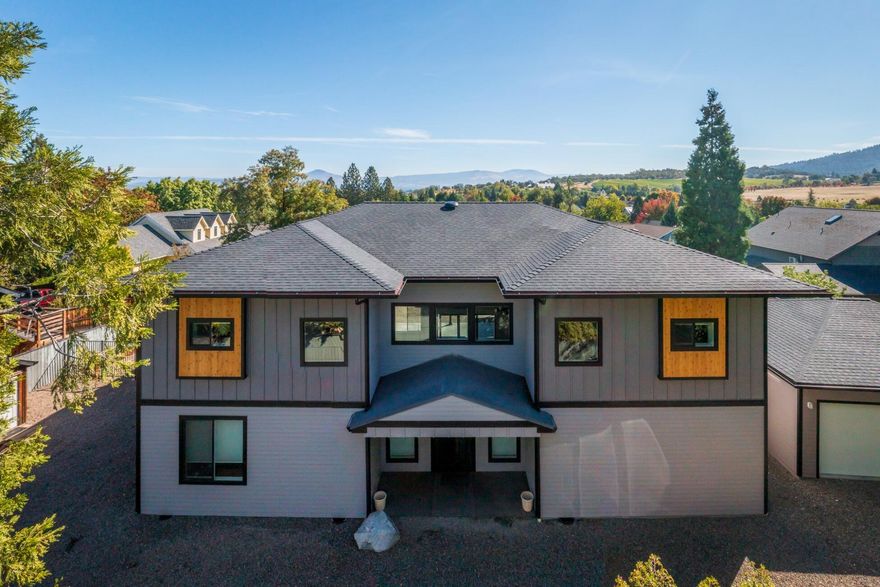 Experience contemporary living in this exquisite home with guest house on a large, wonderfully located lot, in historic Jacksonville. Be swept away with 4,192 sq.ft of modern finishes, split floor plan featuring 4 bdrms/5 bth; 3 of which are en-suite with walk out balconies with valley/vineyard/mtn views! Amazing entry to living room with 21 ft. ceilings, gas in-wall fireplace with floor to ceiling wood accents from The Historic Cardwell House. Main room windows and shades are remote control and compliment the powered telescoping sliding glass door. Two tone quartz counters, soft close cabinets, black stainless steel appliances, large breakfast bar & wine fridge! Oversized pantry and laundry area, spacious office plus a theatre room. Upstairs primary bath has heated floors, soaking tub, walk in shower, gigantic closet with private laundry. Main home and Guest home each have 3 car garage! Fire suppression system, custom tile and LED lighting throughout! 3 blocks to shopping & dining.