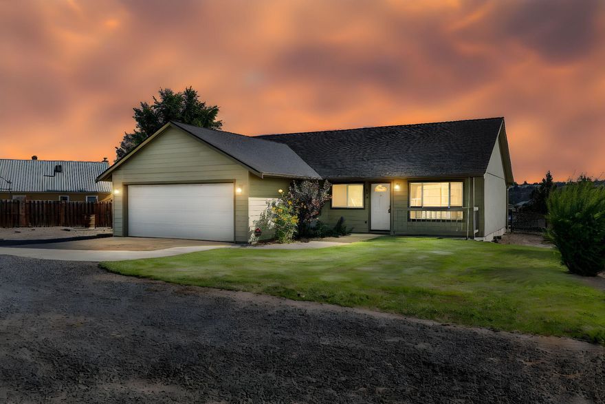 Nestled on a spacious 0.33-acre lot on the ridge, this well-maintained home offers a rare blend of privacy and convenience in the heart of Madras. Enjoy a newly paved road and a tucked-back driveway that creates a feeling of seclusion. The inviting covered front porch welcomes you into an open great room concept, ideal for gatherings. Featuring 3 bedrooms and 2 bathrooms, including a large primary suite overlooking the backyard with a recently updated walk-in shower. Forced air heat and central A/C ensure year-round comfort. The landscaped yard is equipped with underground sprinklers for easy care. An attached double car garage completes this desirable property. A wonderful opportunity to own a centrally located retreat with modern updates and excellent livability.