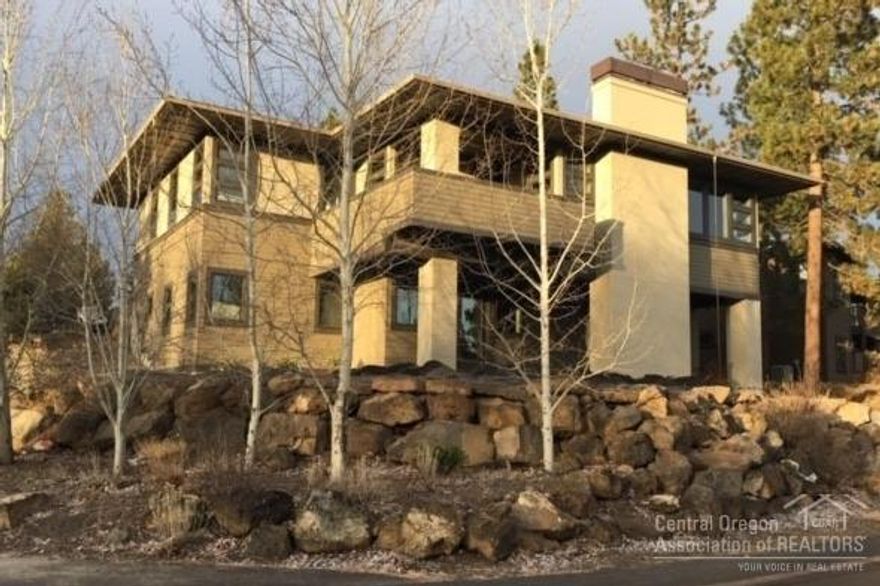 Located in desirable Three Pines, this extraordinary Prairie-style home is poised on a spacious corner lot overlooking treed open space, only steps to a neighborhood park and the paved walking/biking trail to Bend's 650/ac Shevlin Park. Experience a wonderful home that feels NEW, as it won't disappoint the most discriminating buyer. Featuring spacious main level living, a chef's dream kitchen, three bedrooms all w/private bathrooms & walk-in closets, an expansive, multi-use family room downstairs (shown as a huge library)...all in a light-filled, modernist interior space showcasing an array of beautiful features and appointments.