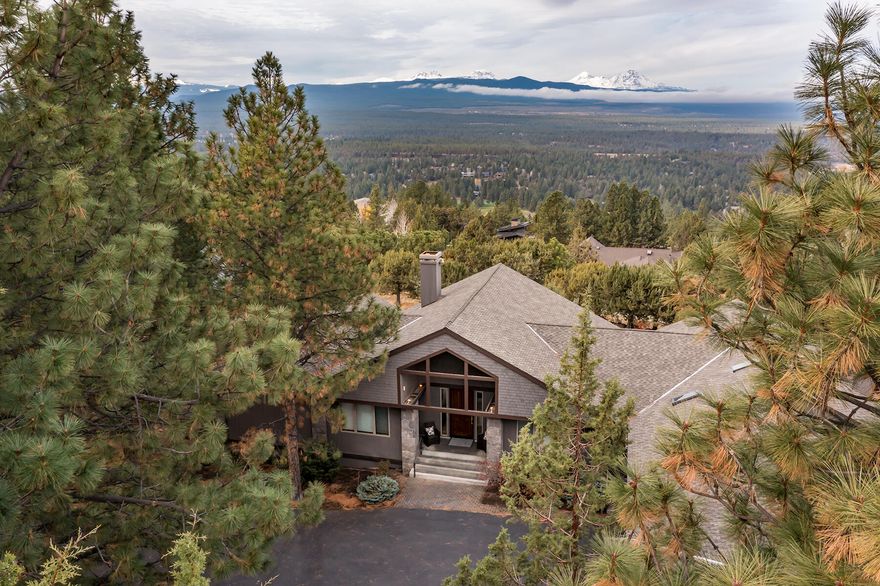 Absolutely breathtaking Awbrey Butte custom built home with panoramic Cascade Mountain Views from Mt Bachelor to Mt Hood on over 1 acre. Carefully constructed by Brock Home Builders with attention to detail at every turn. Meticulously maintained with an open living room with massive vaulted ceilings, cozy fireplace with stone hearth, gorgeous built ins and floor to ceiling windows to marvel at the beautiful views. Spacious chef's kitchen is complete with granite counters, breakfast bar on the large island, and extends to the family room with additional fireplace, built-ins, and much more. Private primary suite with huge master bath with double vanity, jetted tub, and walk in closet. Don't forget about the designated office with murphy bed and built-in work station, large formal dining room, and day light basement bonus room. Amazing outdoor living at it's finest with extensive decking, paved patios, and hot tub. This is a truly special home. Call for your private tour today.