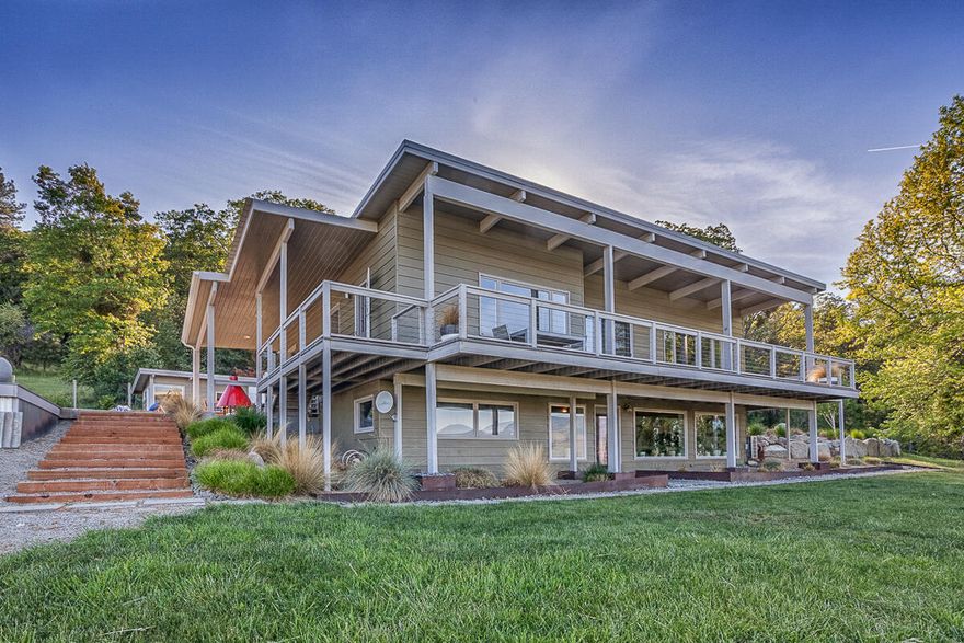 Incredible and panoramic views from this gorgeous, contemporary style, updated atomic ranch home overlooking rolling irrigated pastoral grounds.  All main level living: primary bedroom & bath, guest bedroom & bath; nice light and bright kitchen with dining area that opens up to the living room with open beams, extensive windows; solid maple flooring and fireplace with flagstone hearth.  Custom in-ground pool, detached cabana and dry sauna.  Wrap around decks with custom cable railing for entertaining and pure enjoyment of this one-of-a-kind setting.  Downstairs you will find additional bedrooms, family room and storage room with built-in shelving.  the 14.74 acres are fully irrigated from Clayton Creek, fenced & cross fenced.  There's a solidly built 4-stall barn with tack room, solar electricity, a wash rack, covered equipment storage; plank flooring throughout.  The property is clean, ready to go and has a ton of potential uses - from vineyard to horse ranch - for your Oregon dream.