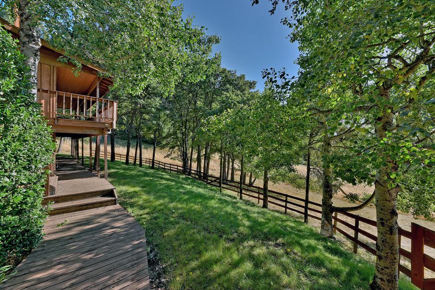 Enjoy country living in the hills of Ashland! Located off Dead Indian Memorial Rd and close to mountain lakes, this beautiful property is a true Southern Oregon dream. The spacious 3 BD/2 BTH home sits on over 8 acres of partially wooded land with plenty of space for a small farm or pasture! This home gives a modern cabin feel as you enter, with the living room providing plenty of natural light, a cozy wood stove and built-in shelving. The lovely dining room is equipped with large bay windows and connects to a spacious kitchen with ample counter/cupboard space and large pantry! Each bedroom is good size with the primary bedroom equipped with a large walk-in closet, full bathroom and door leading out to the back deck. The expansive wrap-around deck is perfect for entertaining guests and enjoying the fresh mountain air! The property also boasts a large daylight basement, 2-car garage and huge barn! Don't miss out on this Southern Oregon gem, call to schedule a showing today!