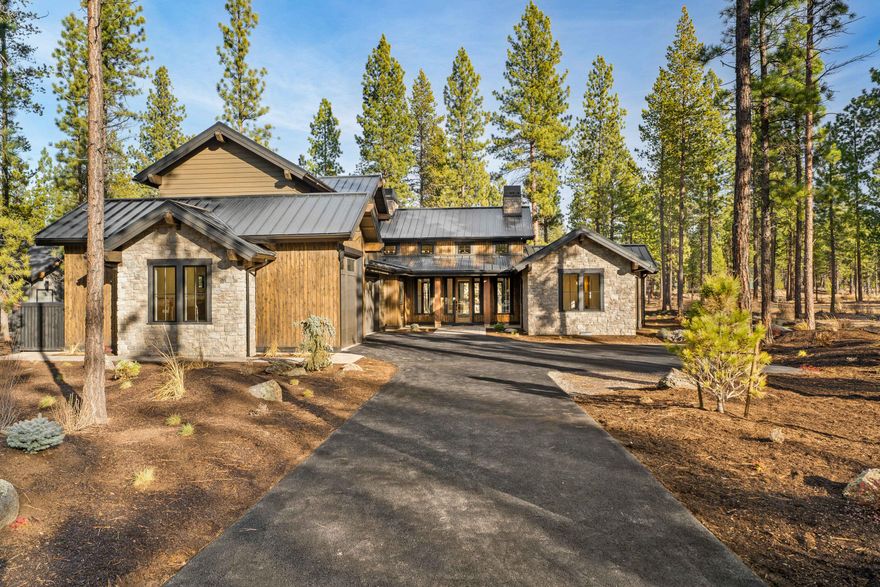 Experience refined living in this new 5-bedroom home by Curtis Homes LLC, located in the heart Caldera Springs-the Pacific Northwest's premier residential resort community. Thoughtfully designed with elegance and functionality in mind, this mountain-contemporary styled home offers luxury comfort across a generous half-acre homesite with serene stream views. Inside, a soaring double-height great room seamlessly flows into a vaulted dining area and chef's kitchen with large walk-in pantry, spacious island and separate breakfast nook.   Expansive glass doors open to covered outdoor living, creating a seamless indoor-outdoor connection. The main level offers a well-appointed primary suite complete with a fireplace and luxurious en-suite bath, along with a secondary en-suite and a third bedroom. Upstairs features two additional bedrooms, a spacious bonus room and a full bathroom. Live the Caldera Springs lifestyle with access to year-round resort amenities-20 minutes to downtown Bend.