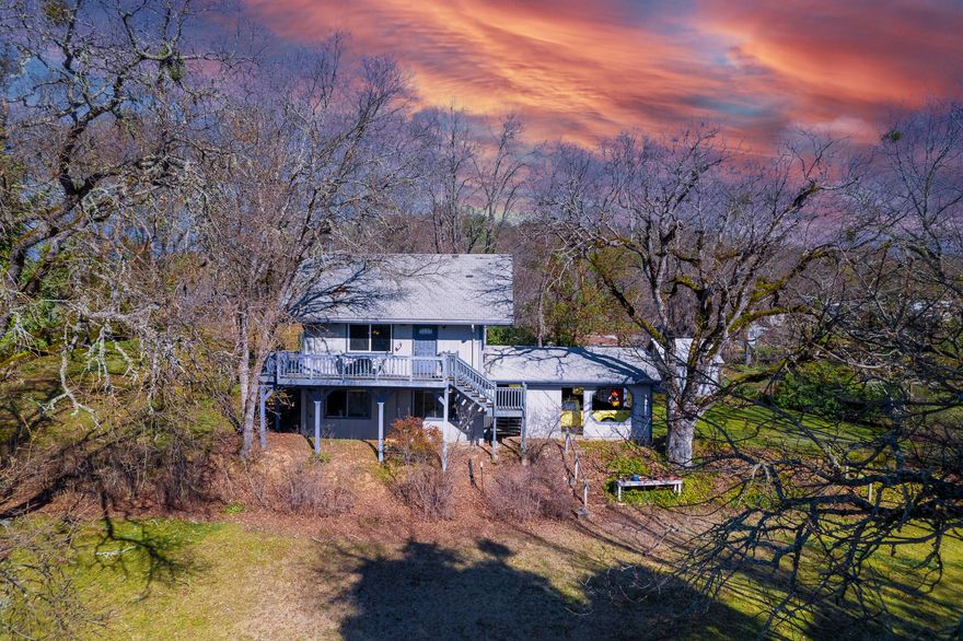 Sitting right outside of Gold Hill on almost a full acre, this cozy home is centrally located and perfect for the minimalist lifestyle. This home offers an open floor plan for the main living space and a large loft for the bedroom. Some features include high ceilings, newer engineered oak flooring, vinyl double paned windows and all the opportunity to make your own! Outside, the attached spacious two vehicle carport will lead you into the daylight basement! Where you will be pleasantly surprised to find a small workshop, perfect for a woodworker or hobbyist! There is also a laundry area, small half bath and a bonus room that with some light work could make for a second bedroom, gym space or other! The land has been lovingly maintained over the years, has easy parking, and all the potential! Please contact your Agent and schedule your showing tour today!