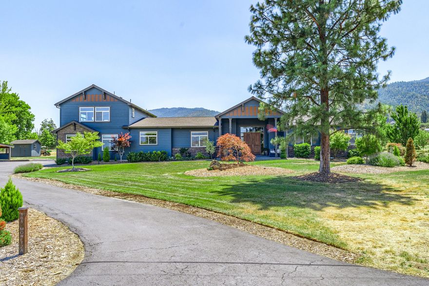 Gorgeous home with a park like setting. Irrigated, with many species of trees, shrubs and wide-open lawns for enjoyment and play. Rural Ashland, close to Emigrant Lake, yet only minutes to City services, shopping, and convenient I-5 access. Mostly single level living with 3 beds (+ office) and 2 1/2 baths on the main. Large primary bdrm suite has access to the backyard patios, dual vanities, shower, soaking tub and walk-in closet. Open floor plan has a spacious kitchen with stainless steel appliances, granite countertops and a large center island that overlooks the dining area and into the living room w/ tall vaulted ceilings and impressive floor to ceiling rock fireplace. Natural light pours in through the many windows capturing spectacular views. Huge upstairs, versatile family room with another full bath, perfect space for overflow guests, T.V. room, or whatever your heart's desire. Attached two-car garage w/ 3rd bay. Large detached shop w/ carport. So much is being offered here!