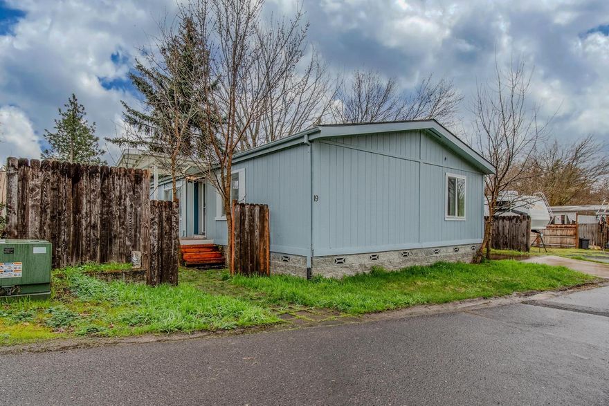 Welcome to this delightful double-wide manufactured home in an all-ages park in Ashland featuring 3 bedrooms & 2 baths. This inviting residence boasts a spacious open, split floor plan with bamboo floors in the dining room, kitchen & laundry, perfect for modern living. Located in a prime spot within the park, it offers peaceful views of the surrounding hills & valley. Built in 1990, the home has been lovingly maintained. The primary bedroom is generously sized & includes long closets, while the attached bath features a shower & relaxing jacuzzi tub for your comfort. Convenience is key with a back door leading from the driveway directly into the laundry room, which is conveniently adjacent to the second bath.  The kitchen is a cheerful space, enhanced by a skylight & white cabinets that brighten the room. Don't miss the opportunity to make this beautiful home your own. With its prime location & thoughtful design, it promises a comfortable & serene lifestyle. Owner carry possibility.