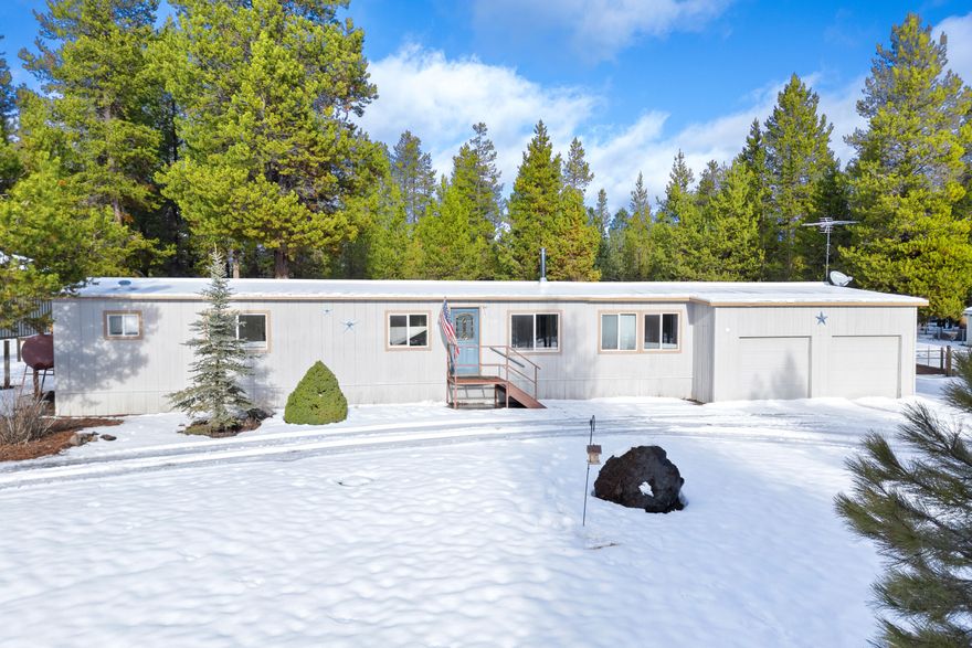 Step into this well-maintained 3-bedroom, 2-bathroom manufactured home nestled on a beautifully landscaped 1-acre lot surrounded by trees. A large Trex deck compliments this beautiful backyard. Peaceful and private! Perfect for those seeking tranquility and outdoor adventure, this property is located near La Pine State Park and public lands, making it ideal for recreation enthusiasts and their toys. Brand NEW well and water system installed! Efficient free standing oil stove in the front room, kitchen is light and bright! Two car garage, circular drive as well, metal roof with edge membrane. This is a must-see home!