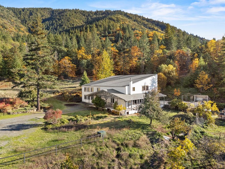 THANKSGIVING SPECIAL- offer good through November 30th. Special holiday price and seller to pay $10,000 toward rate buy down or closing costs if under contract by 11/30. 
It's not every day that an amazing opportunity comes along! This home, with many bedrooms and an abundance of space, was designed with a passive solar system that makes heating and cooling very affordable. The 20 acre property backs up to BLM and has no visible neighbors so you can frolic as you please in your meadow and savor your favorite beverage outside on the covered porch even if it's raining. Some of the rooms are incredibly spacious. And the main floor is accessible for wheelchairs and walkers. Outbuildings include a 4 car garage and workshop space, an additional garage, a covered RV parking space, and an older barn that once housed sheep. 
New roof installed summer of 2025. 
You'll have so many choices on how to use the space both inside and out. Where to begin? Call now for your personal tour.