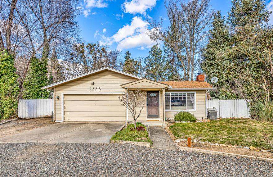 Fantastic light and bright home with a shop!  Property is located in a great Central Point neighborhood and sits on .41 of an acre. This home features 3 bedrooms, 2 bathrooms, (one bathroom has been beautifully remodeled) 1317 sq ft, updated refinished hardwood floors and vinyl tile floors. Great living room with large front-facing window. Charming vintage-style kitchen offers glass cabinets, newer glass range/oven and a window opening that overlooks the dining area & living room. Recently remodeled bathroom features natural stone floors, tile shower, lovely vanity, power-assist flush toilet. New light fixtures, including recessed lighting in dining & living room. Laundry room has walk-in pantry.  Great shop is approx. 300 sq ft with 220-amp electricity. Outdoor spaces are wonderful with sitting areas, new fencing, and mature landscaping. Irrigation rights (currently $246/year) with pump waters the lawn in the summer. Attached 2 car garage and gated RV parking. Home is move-in ready.