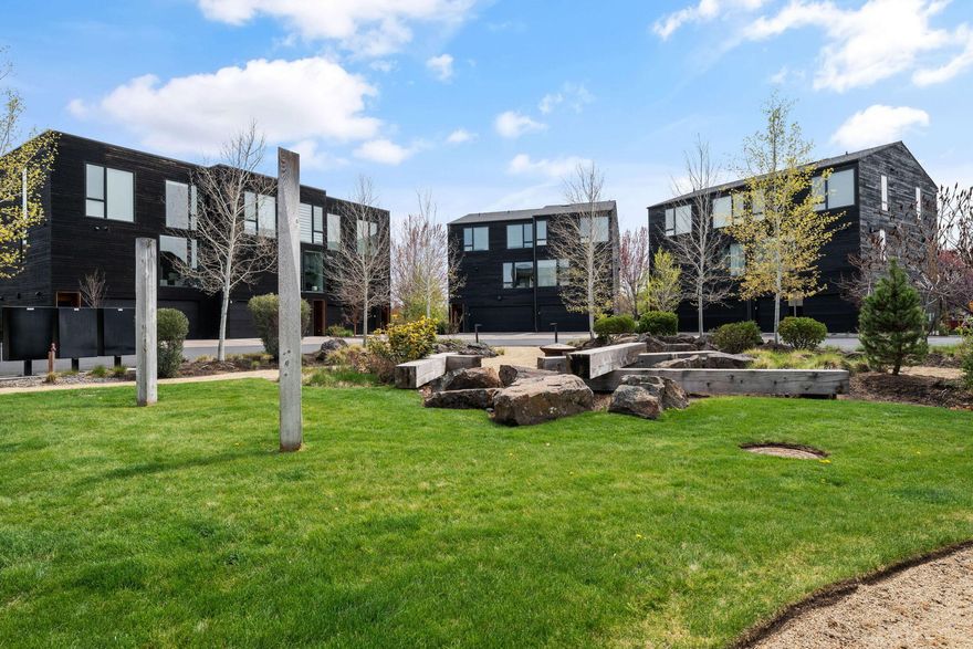 Easy walk to all that Bend has to offer!
Owner financing available at 5.5% for 3 years!! The best of Bend at your doorstep! This modern Basecamp townhome blends natural elements with contemporary design offering style, sustainability & an unbeatable location. Thoughtfully designed with flexible living spaces, the entry-level suite is perfect as a guest room, home office or private retreat.
Upstairs, the open-concept main level features a sleek chef's kitchen with luxury appliances & clean, modern finishes. The cozy living area is anchored by a chic Scandinavian-style fireplace, while the sun-drenched dining room leads to a striking floating staircase and upper-level loft.
The third floor offers two bedrooms & serene separation of space. The second-floor balcony is your front-row seat to Bend's most iconic views, perfect for morning coffee or sunset unwinding. A two-car garage provides room for all your Central Oregon gear. Just steps away from  the river & downtown.