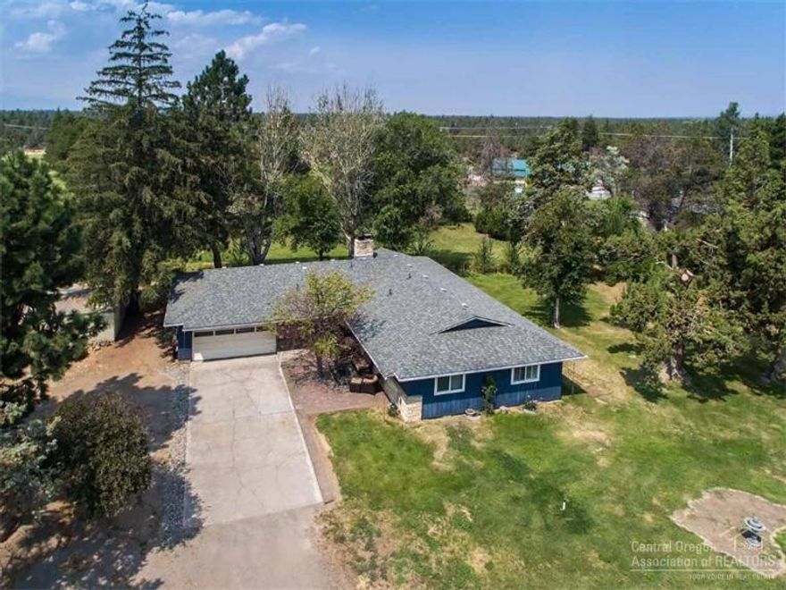 Small acreage close to town with a single level home and shop. Comfortable living room with big windows and a wood stove insert. Beautiful gourmet kitchen with granite counters, a gas cook top, stainless steel double ovens, microwave and refrigerator. Lovely interior paint colors, tile, carpet and laminate flooring, and a new roof. Room for the toys in the 720 sq. ft. shop. There is also a 224 sq. ft. greenhouse. All on 3.91 acres with 2.5 acres of COI irrigation, a fenced pasture and a dry lot for animals.