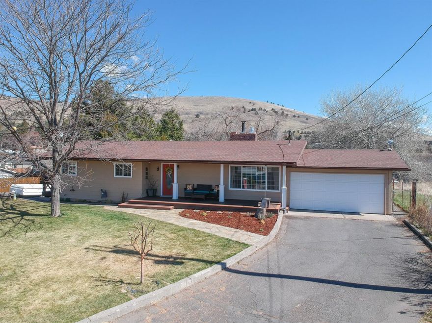 Remarkable privacy and view from this .75/acre lot. Lovingly remodeled by owner in farmhouse style decor. 3 bedrooms and 1 bath on main level. Downstairs family room could be a master suite. Laundry area could be extra kitchen with mini fridge and microwave. Separate entrance gives Air B & B possibilities. Approximately 608 sq. ft of basement is shop. White washed plank flooring, farm sink, concrete counters. Freestanding kitchen cabinet included in sale. TV antenna brings over 17 channels. Fruit trees, thornless blackberry patch, grapes, raspberries, wild celery and rhubarb. Chicken coop. Enterprise irrigation. Domestic well for household water. Driveway easement on north gives backyard access. Own your own little farm in the suburbs.