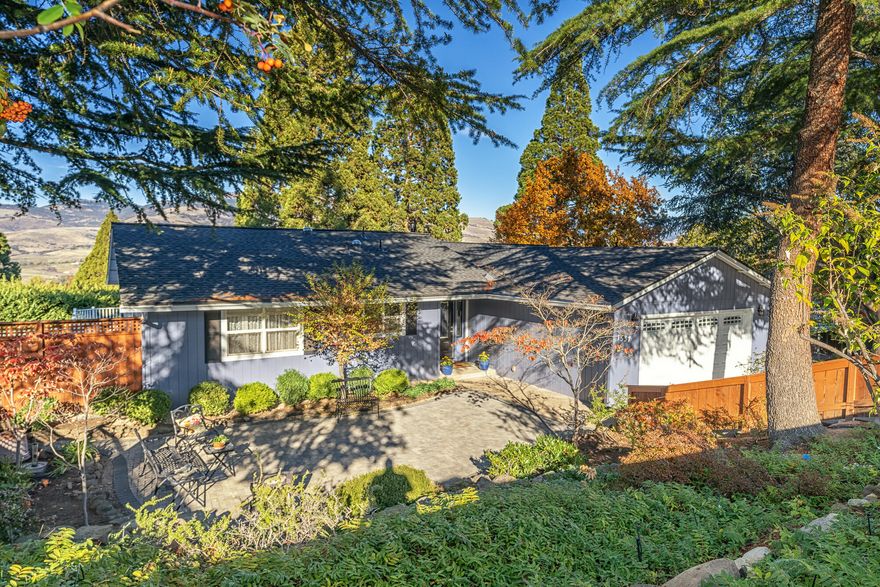 Flooded with light and offering sweeping views of mountains and trees, this exceptional home is situated in a very desirable Ashland neighborhood and offers both privacy and convenience to shopping and services. The low-maintenance landscaping is offset by a wrap-around deck, a beautiful new paver courtyard in front, and additional areas for outdoor enjoyment.  Inside, the main level offers a large living room, dining area, 3 bedrooms and 2 full baths.  The kitchen, equipped with stainless-steel gas range, refrigerator, and microwave, has a granite island and countertops. Downstairs, there's a large flexible bonus room with a third full bath, kitchenette, built-in cabinets, and patio access. This gem of a home has been well loved and maintained including installation of a new 40-year roof in 2020 as well as new exterior paint and shutters. SELLER MOTIVATED!