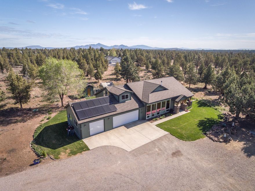 Live life as it should be lived, calm centered and peaceful.  This is truly a one of a kind custom built functional and very livable home and unique property.  Its location is extremely convenient and is adjacent to 1100+/- acres of public land and the Deschutes river right from the property.  Some of the many features and benefits include a ground level master bedroom for easy living, zoned heating and cooling for year round comfort, radiant floor heat, Quadrafire brand wood stove, large bonus room/office, a smartly positioned south facing home orientation with solar panels to capture energy, attached triple car garage for quick access parking and storage, greenhouse, storage shed, dog kennel, tree house, large barn with additional covered vehicle and RV/trailer/boat parking as well as a workshop and a temperature controlled loft AND a private pickle ball court.  This is a special place and an opportunity not to be missed