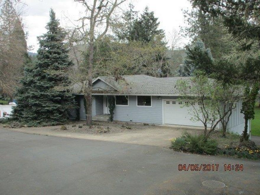 Great Rogue River front property with lawn down to the banks. The home has a lot of potential possibly a two family setup, buyers to do their own due diligence, with a second kitchen. The upper level has large living room also master on main level. Daylight basement offers a kitchen, family room, full bathroom, utility room plus a bedroom and two bonus rooms. Lots of deck and patio area to enjoy. There is an upper and lower attached garages plus a detached garage and nice RV paved parking area.