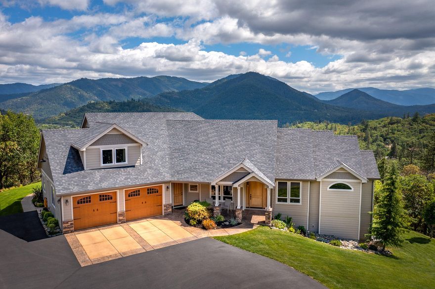 The amazing view will captivate you the moment you walk into this elegant custom home. Just mere minutes from the freeway and town, yet quiet, private, and above the normal fog line. Vaulted and coffered ceilings, and a flow through floor plan that takes advantage of the view! The main level has the Master suite with his n hers walk in closets, double sinks, a clawfoot tub, tile shower, and a great view!. A separate office is just off the entry, formal dining, pantry, living room, family room, powder room, laundry room, 2 more bedrooms, and a large kitchen with granite counters, a large island with a farm sink, and double ovens. The second master suite is the entire upstairs with its own bath and sitting area. Electric gated entry and a paved driveway lead up the stamped concrete garage apron and walkway to the front porch. The rear covered patio and walkway are  stamped concrete, and has a pondless water feature. Beautifully landscaped. This home is stunning and ready for you!!