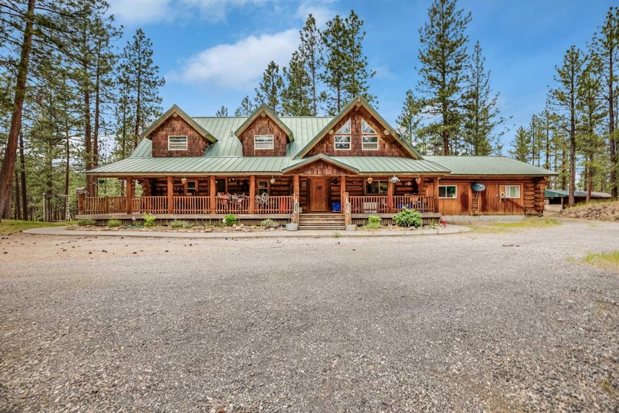 Custom built 3,372 sq. ft. Hand Scribed Log home situated on 38.40 acres that adjoins US Forest Service land.  Relax on the wrap around deck with lots of windows to enjoy the wildlife and Ponderosa Pine trees. Home features 6 bedrooms, 2 full baths and 4 half baths. Included on the property is a 2160 sq. ft. shop with a 1200 sq. ft. living quarters, 2 bedroom and 1.5 bath which is not included with the square footage of the home. Fenced in backyard and a 12x24 storage shed. RV hook up and parking. It's a place where you can find solitude, adventure, and recreation right outside the door!