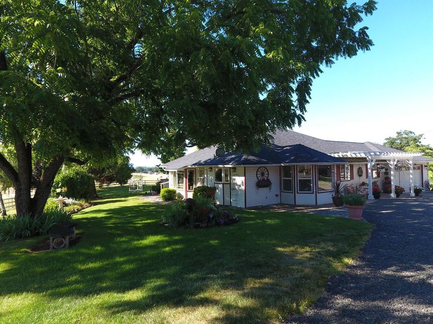 21.97 acres with water permit for 12.1 irrigated acres from the well. Everything you could want for exquisite country living. Beautiful setting, with large oak trees, shaded lawn, deck, fruit trees, and established garden boxes. Outbuildings include, 3 stable barn, double shop/garage, hay barn and feed barn for the Fallow deer. 3 pastures have 8-foot fencing to accommodate the licensed deer operation. The home has been updated with new roof in 2012, Remodeled County Pine Kitchen, high quality laminate oak wood floors and Xtrordinair fireplace. The living room and Master bedroom have French doors that provide access to the deck, jetted tub in the master bath. The hall ways are extra wide with 3'0 doors to all the rooms for easy access. The adjoining 5 acres will be available; sellers are doing a legal lot of record application with the county.