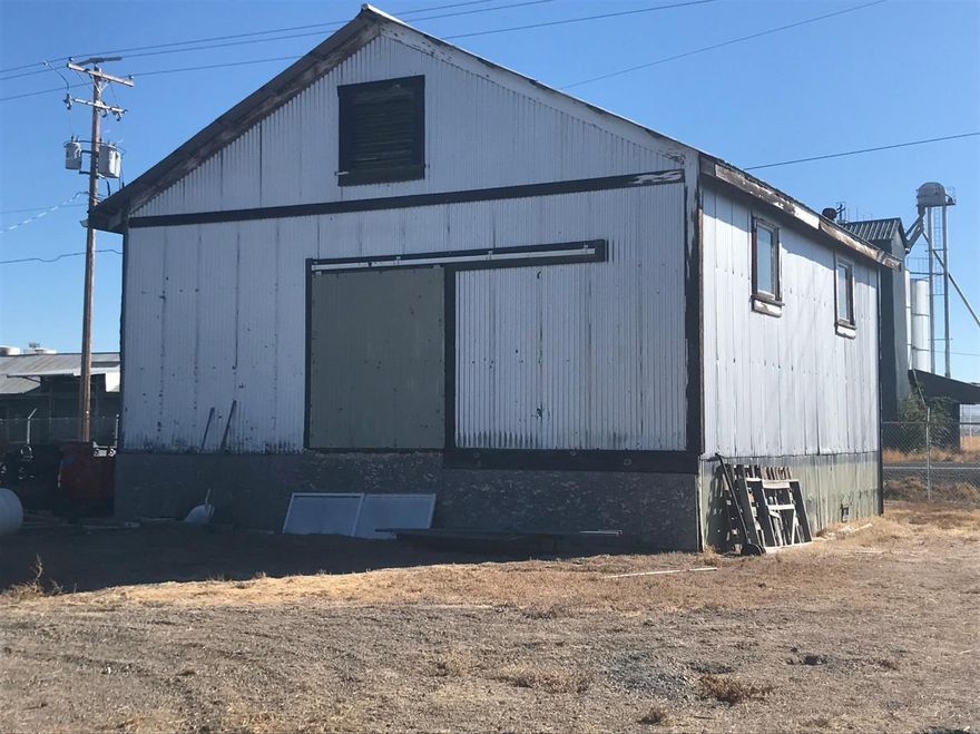 Shop on an Acre! 25 X 30 Insulated/Heated Shop with Three phase electric. Zoned commercial, this shop also includes: Air Compressor, Drill Press, Bench Grinder, Parts washer, Welder, Battery Charger, Plasma Cutter, Torch, and a lift! 2 post 11000 lb lift (wheeltronic) also included: 8 1/2 X 24 ft container. Additional storage building and office with bathroom. Fenced with cyclone fencing, level graveled parking area.