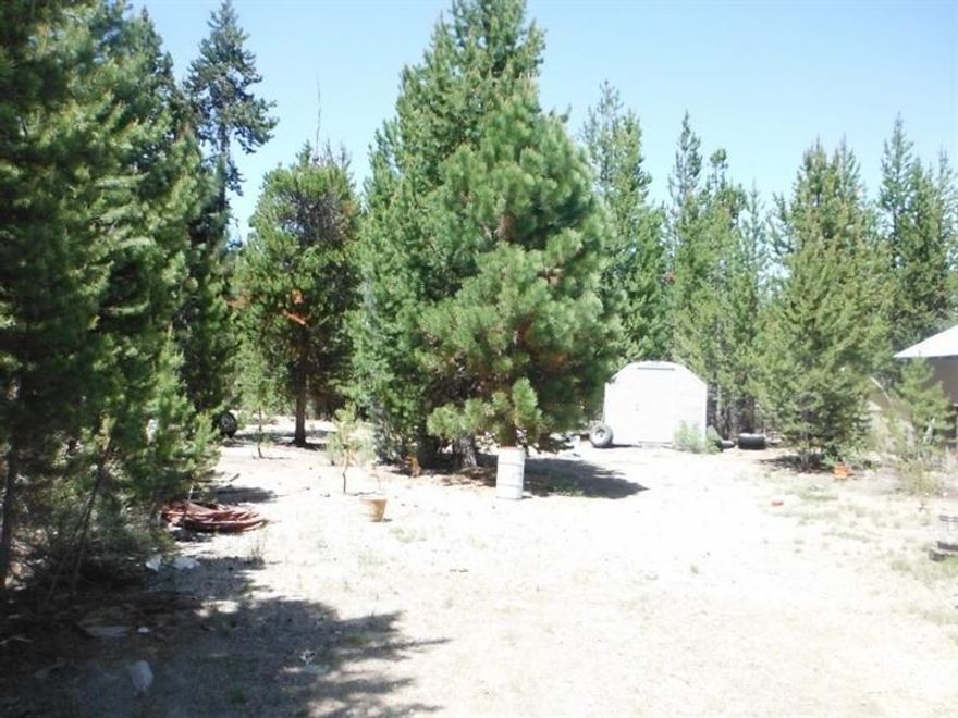 Steps to USFS land, this 2+ acre parcel is located in Two Rivers North and has alot to offer. The home is being sold as is and would make a great project house. The massive snow roof, covered RV parking, circular drive, storage buildings, built on frame living room make this a steal at this price. The utilities and well are in! Don't miss out on a great opportunity. Minutes from fishing, skiing or snowmobiling from your backyard.