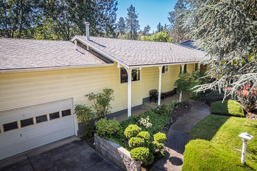 Massive price reduction on this huge HALF ACRE property and charming house with views located very close to Historic downtown Jacksonville! Potential everywhere you look in this beautiful and well-kept home is situated on 2 peaceful tax lots totaling a half acre. The house is a spacious 3-bedroom, 2-bathroom home with a huge back deck surrounded by mature trees, sunshine, and views! Enjoy tons of counter space in the sunny kitchen that includes 2 sinks and plenty of cupboards for storage, as well as a comfortable living room with charming red brick fireplace. The master is very spacious and includes a big walk-in closet. Huge 2-car garage and plenty of parking. This property is a gardeners delight and a very tranquil setting. Listing agent is related to seller.