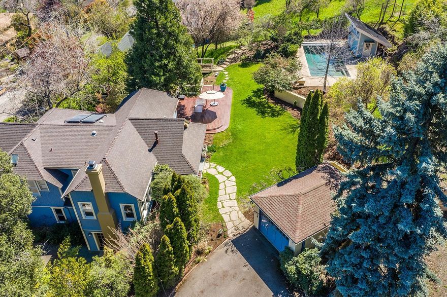 Charming and rare family compound with two extensively renovated historic homes, just 5 blocks from Ashland's Lithia Park and downtown plaza. Serene landscaped grounds with mature trees and perennials, lawn, mahogany deck, terracing, and pool. Main home features a vaulted great room, birch floors, gas fireplace, plaster walls, wood-wrapped windows, gourmet kitchen with quartz island, alder wood cabinets, oak chopping block prep area, pantry, and stainless appliances. Master suite on the main level with balcony, dual closets, and dual vanity bath. Lower level with family room, office, media room with built-in cabinetry and radiant-heated concrete floors, as well as two bedrooms and full bath. Adjacent guest home has multiple exterior entrances and a versatile layout with three rooms on the upper level utilized as home offices, while the lower level has a full kitchen, bath, and large bedroom. Additional amenities of the property include a pool house with full bath, and detached garage.